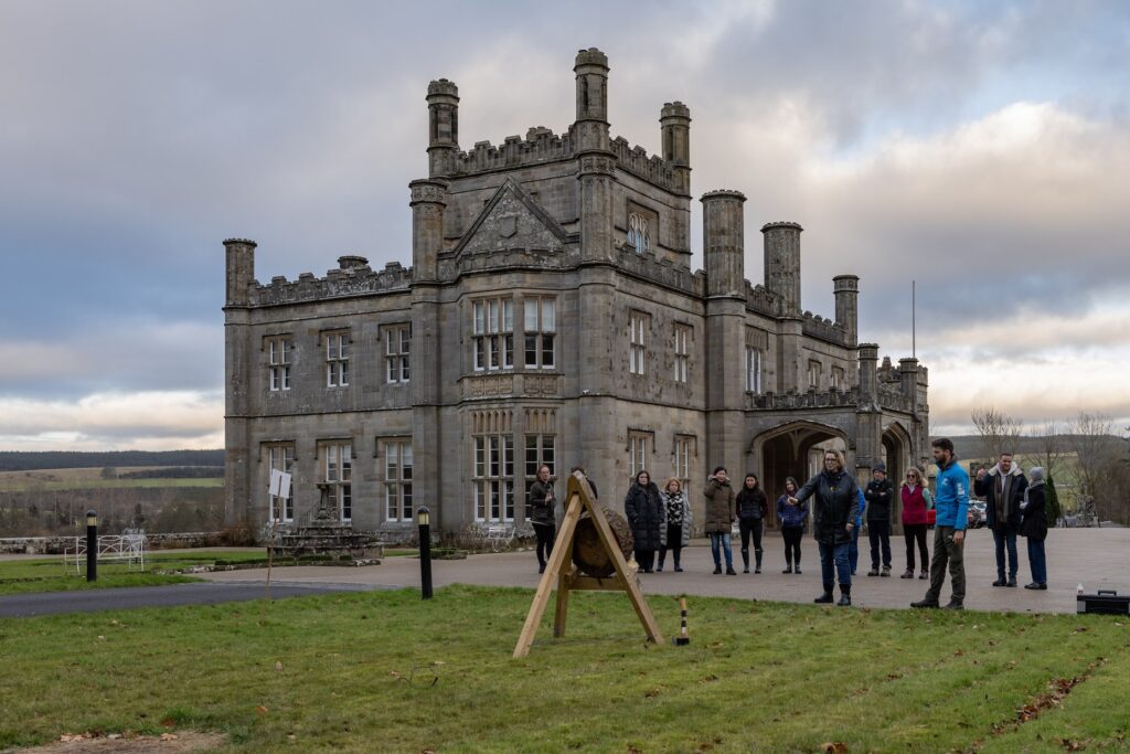 Historic Blairquhan castle with people gathered outside.